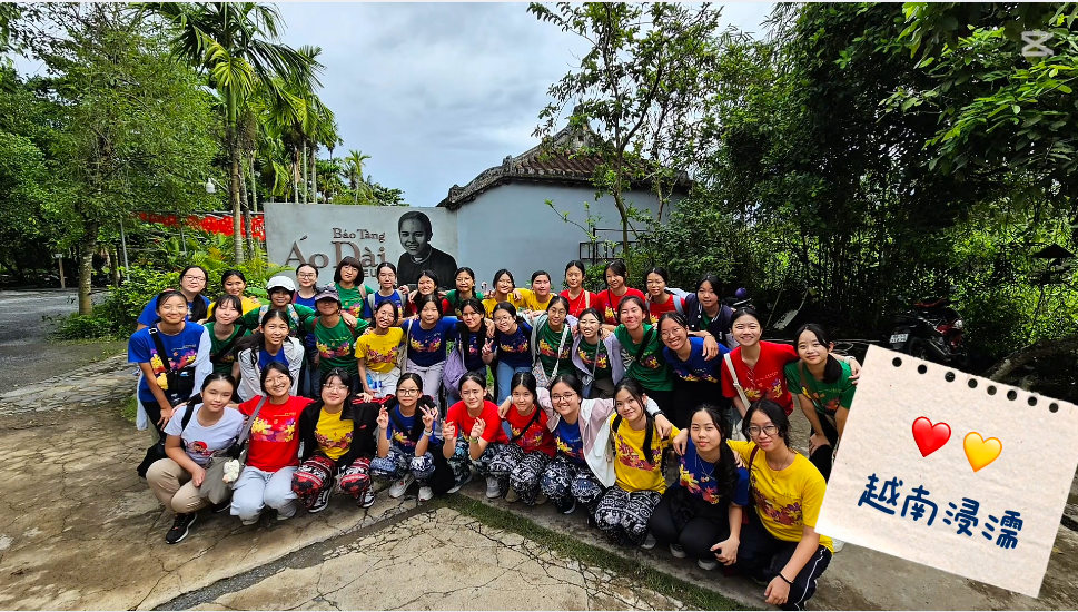 Students posing together outside the Ho Chi Minh Museum during a Vietnam immersion trip.